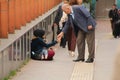 Samsun,Turkey - November 19, 2022 An old man giving money to a refugee beggar woman Royalty Free Stock Photo