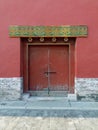 Red door in a red wall, Forbidden City, China Royalty Free Stock Photo