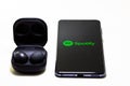 Samsung Galaxy Buds 2 Pro and Spotify mobile application on smartphone screen