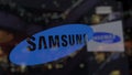 Samsung logo on the glass against blurred business center. Editorial 3D rendering Royalty Free Stock Photo