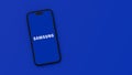 Samsung Logo on Mobile Phone Screen on Blue Background with Copy Space Royalty Free Stock Photo