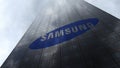 Samsung logo on a skyscraper facade reflecting clouds. Editorial 3D rendering