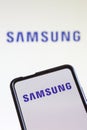 Samsung logo of the television and smartphone manufacturer on a mobile phone and computer screen