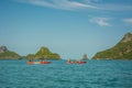 Tourists exploring calm tropical bay with limestone mountains by kayak Royalty Free Stock Photo