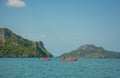 Tourists exploring calm tropical bay with limestone mountains by kayak Royalty Free Stock Photo