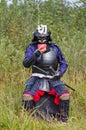 Samurai in armor drinking from bowl