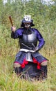 Samurai in armor showing direction by folded fan