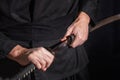 The samurai holding a Japanese katana sword. Photo of a warrior dressed in black clothes in low key Royalty Free Stock Photo