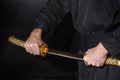 The samurai holding a Japanese katana sword. Photo of a warrior dressed in black clothes Royalty Free Stock Photo