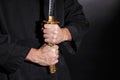 Samurai ready for battle holding a Japanese katana sword. Photo of a warrior dressed in black clothes Royalty Free Stock Photo