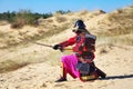 Samurai with sword on the sand. Royalty Free Stock Photo