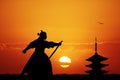 Samurai with swords at sunset