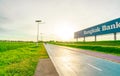 SAMUT PRAKAN, THAILAND-JUNE 18, 2021 : Bangkok Bank advertising billboard with sunset sky and green grass. Sports man ride