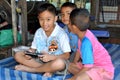 Samut Songkhram, Thailand: Boys with PSP Royalty Free Stock Photo