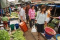 Local people do shopping at the Mae Klong railway tracks market in Samut Songkram, Thailand.