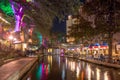 The San Antonio River Walk by night with illuminated trees and restaurants. City park and pedestrian street in San Antonio, Texas