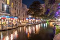 The San Antonio River Walk by night with illuminated trees and restaurants. City park and pedestrian street in San Antonio, Texas