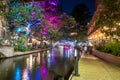 San Antonio River Walk by night with illuminated trees and restaurants. City park and pedestrian street in San Antonio, Texas. USA