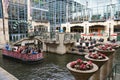 San Antonio, Texas, U.S - April 6, 2024 - The Go Rio boat tour passing the glass buildings of the Shops at Rivercenter