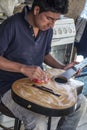 San Bartolome, Ecuador - Dec 1, 2012: Man applies wax to new guitar