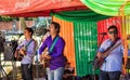 A Paraguayan live band is singing on the German market in San Bernadino, which takes place every Saturday.
