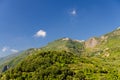 San Bernardino village on the top of green hills with blue sky copy space background, view from Corniglia, National park Cinque Te