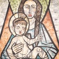 Virgin Mary with baby Jesus painted on a wall of the ancient cemetery of San Candido. Royalty Free Stock Photo