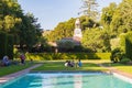 San Carlos, California / USA - June 18 2020: People sit on a green grass at historical Filoli estate weaaring face masks during CO