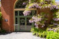 San Carlos, California, USA - May 05, 2019: Entrance to Filoli garden gift shop with blooming purple wisteria in spring