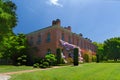 San Carlos, California, USA - May 05, 2019: Filoli estate in spring time with purple wisteria climbing on the brick walls