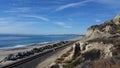 Standing on cliff looking out into ocean next to railroad tracks Royalty Free Stock Photo