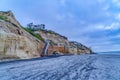 San Diego California beach with mountain houses overlooking ocean and cloudy sky Royalty Free Stock Photo