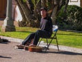 Disabled armless person plays on guitar by his toes