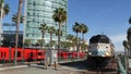 SAN DIEGO, CALIFORNIA USA - 13 FEB 2020: Coaster Commuter and red MTS trolley, public rail transportation in America. Express Royalty Free Stock Photo