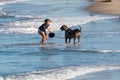 Asian American Woman Plays With Her Dog at Dog Beach