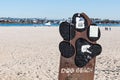 People Play With Dogs Behind Entrance Sign of Dog Beach in San Diego Royalty Free Stock Photo