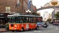 SAN DIEGO, CALIFORNIA USA - 30 JAN 2020: Gaslamp Quarter historic entrance arch sign on 5th avenue. Orange iconic retro trolley, Royalty Free Stock Photo