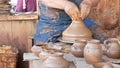 SAN DIEGO, CALIFORNIA USA - 5 JAN 2020: Potter working in mexican Oldtown, raw clay on pottery wheel. Man`s hands, ceramist in Royalty Free Stock Photo