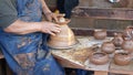 SAN DIEGO, CALIFORNIA USA - 5 JAN 2020: Potter working in mexican Oldtown, raw clay on pottery wheel. Man`s hands, ceramist in Royalty Free Stock Photo