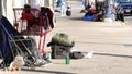 SAN DIEGO, CALIFORNIA USA - 4 JAN 2020: Stuff of homeless street people on walkway, truck on roadside. Begging problem in downtown