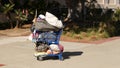 SAN DIEGO, CALIFORNIA USA - 30 JAN 2020: Stuff of homeless street people on walkway, truck on roadside. Begging problem in