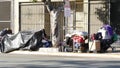 SAN DIEGO, CALIFORNIA USA - 4 JAN 2020: Stuff of homeless street people on walkway, truck on roadside. Begging problem in downtown