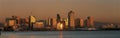 This is the San Diego skyline with the bay in front at sunset. The reflected light on the buildings is golden.