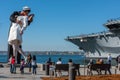 SAN DIEGO, USA - NOVEMBER 14, 2015 - People taking a selfie at sailor and nurse while kissing statue san diego