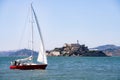 Red Sail Boat in front of Alcatraz island.