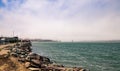 Beach side with rocks and jetty on san Francisco Bay with Golden gate bridge in the background Royalty Free Stock Photo