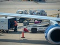 JetBlue baggage handler loading luggage into an airliner at Reagan International Airport