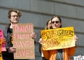 Participants holding signs at a press conf to mark the 10 yr anniversary of the launch of Vision Zero and street safety