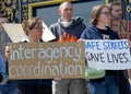 Participants holding signs at a press conf to mark the 10 yr anniversary of the launch of Vision Zero and street safety