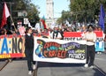 Participants holding signs marching and protesting APEC meeting in San Francisco, CA